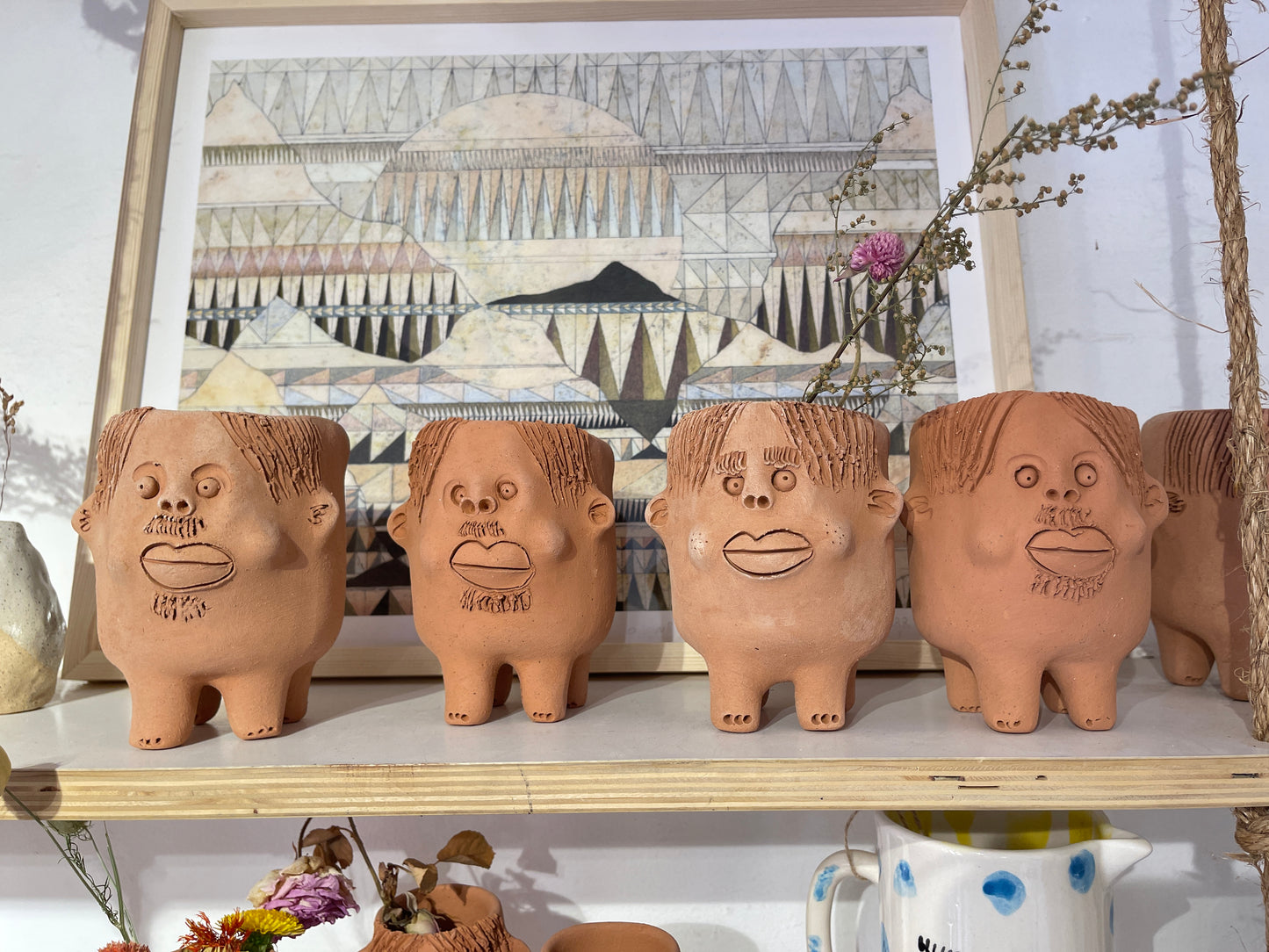 Terracota face planter with legs