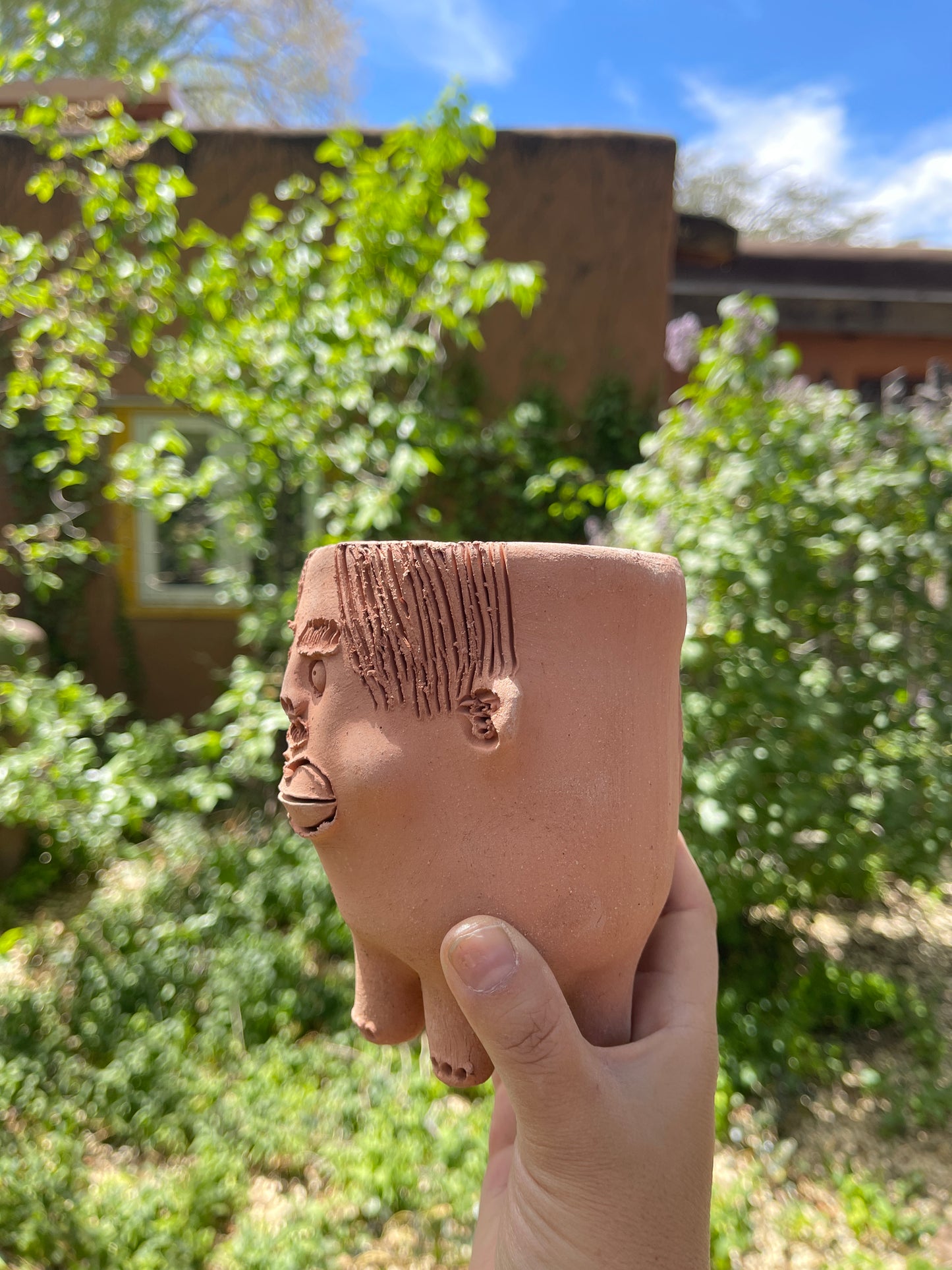 Terracota face planter with legs