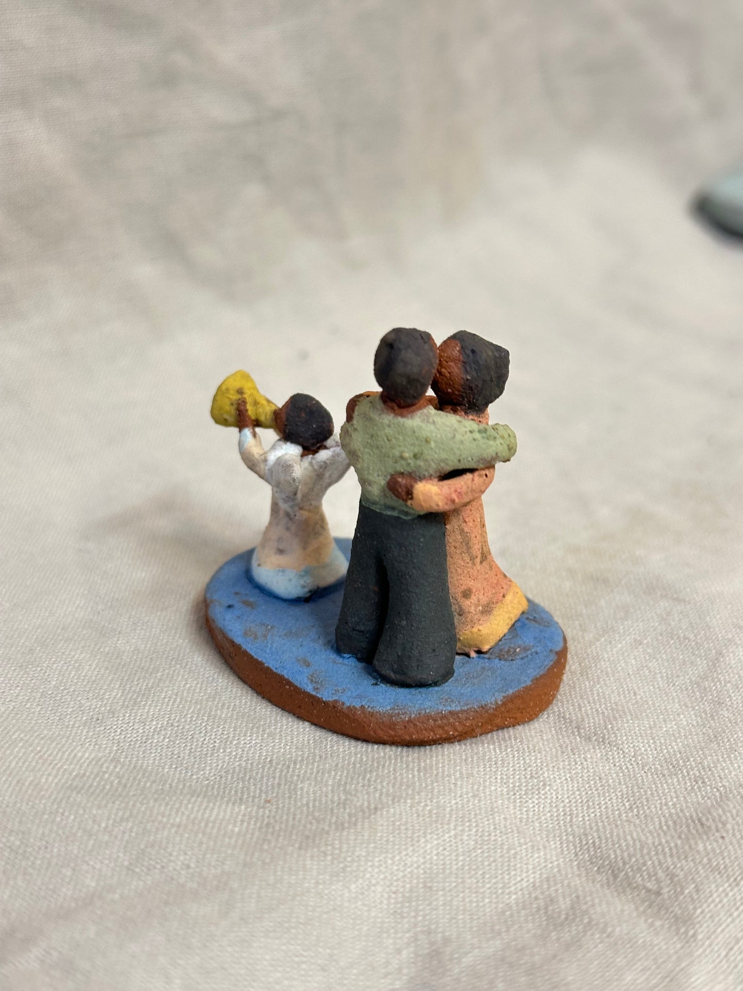 Dancing couple with an angel - miniature clay sculpture