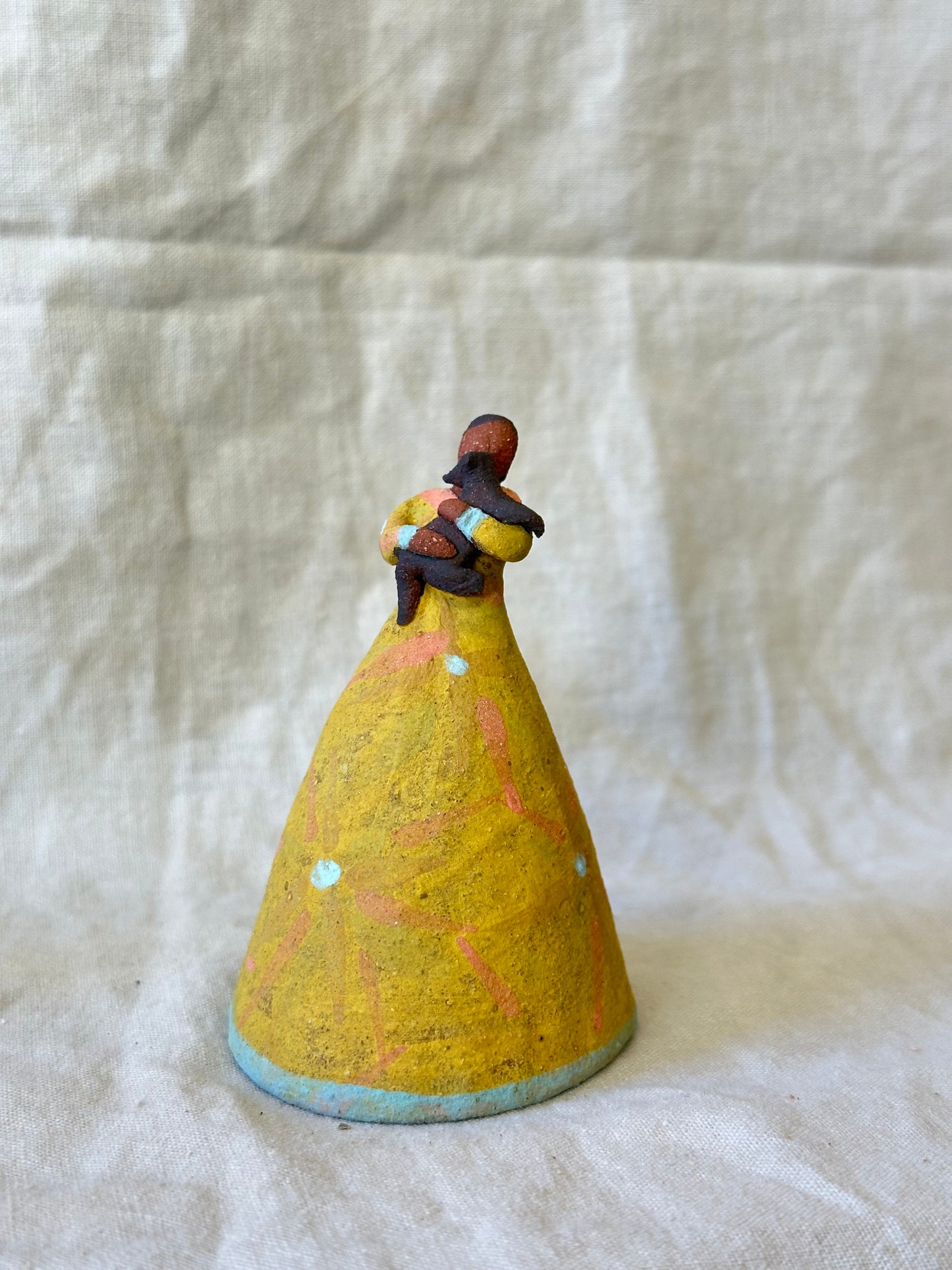 Dancer Bell holding a pet - yellow dress