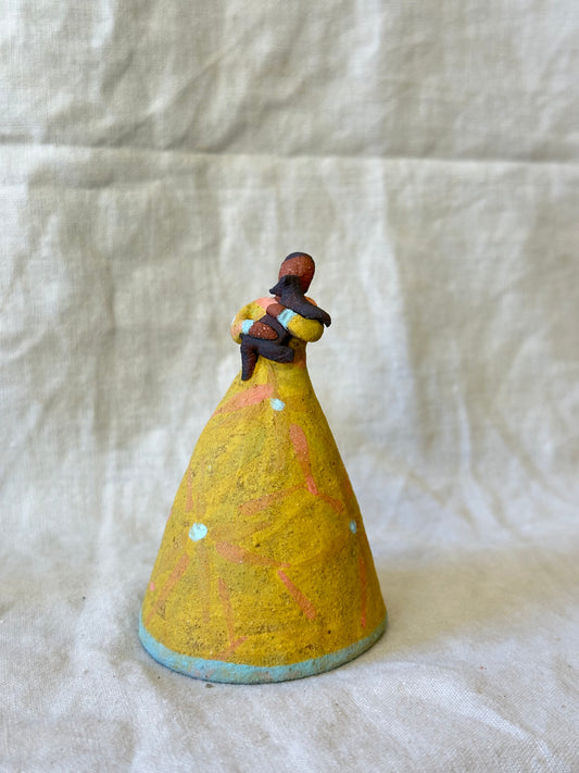 Dancer Bell holding a pet - yellow dress