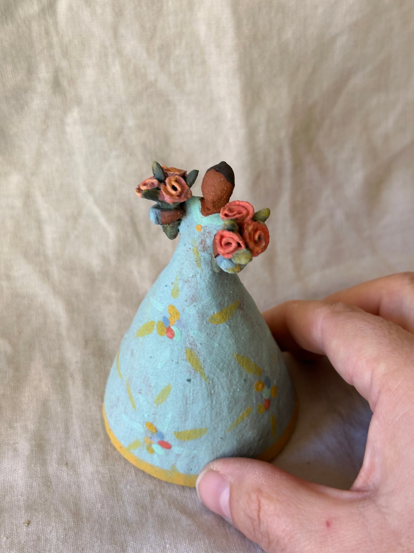 Dancer Bell holding two flower bouquets - light blue dress flower designs