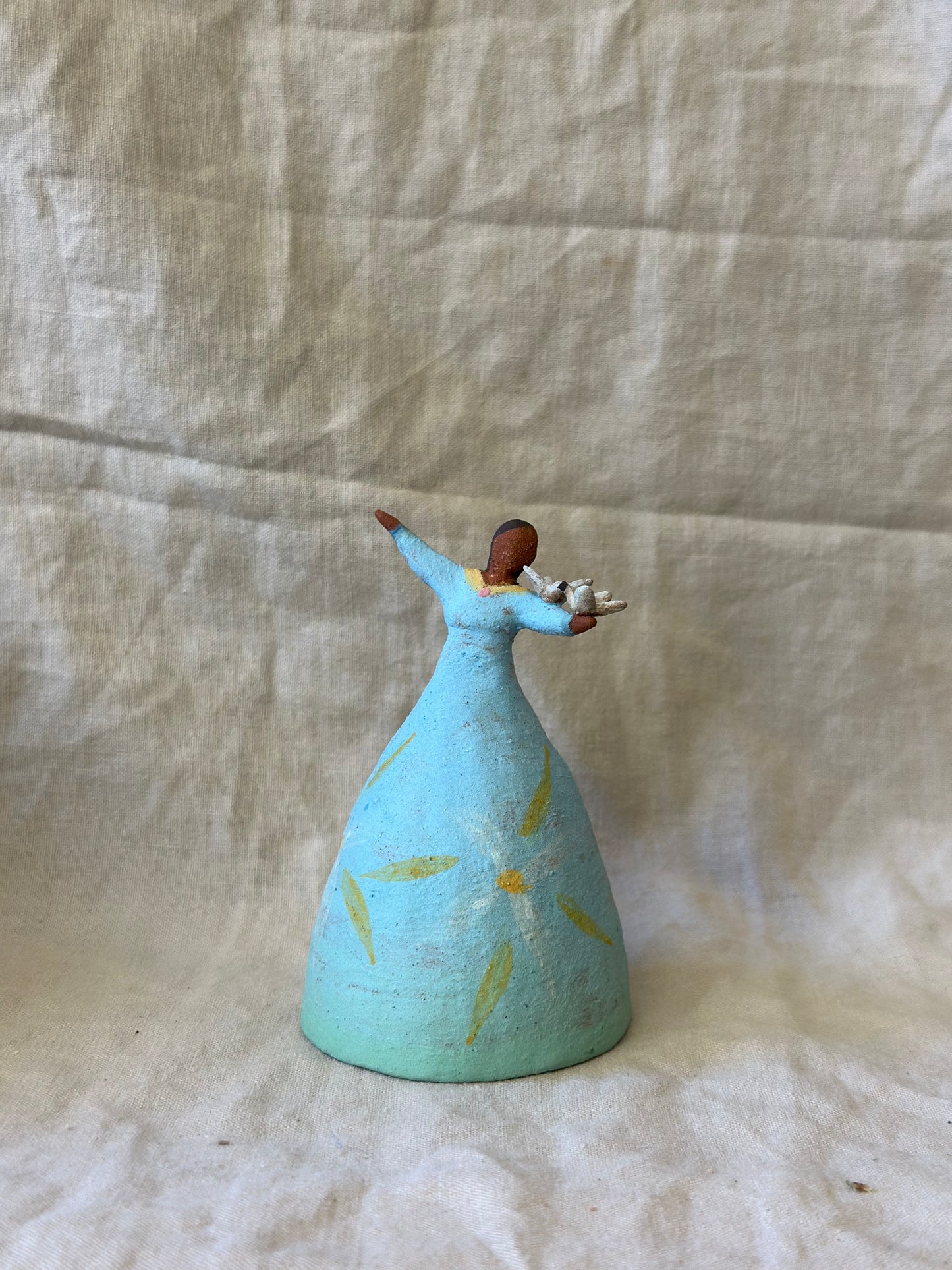 Dancer Bell holding birds - blue dress