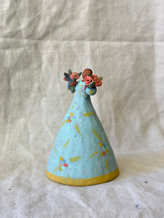 Dancer Bell holding two flower bouquets - light blue dress flower designs