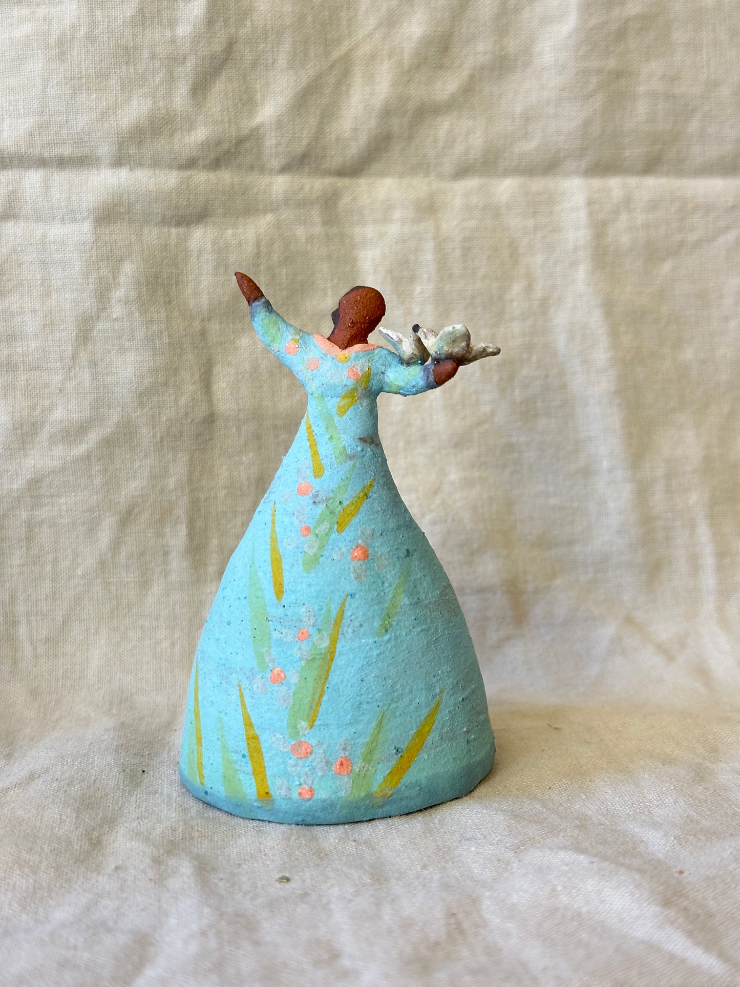 Dancer Bell holding birds - blue dress pink dots accents