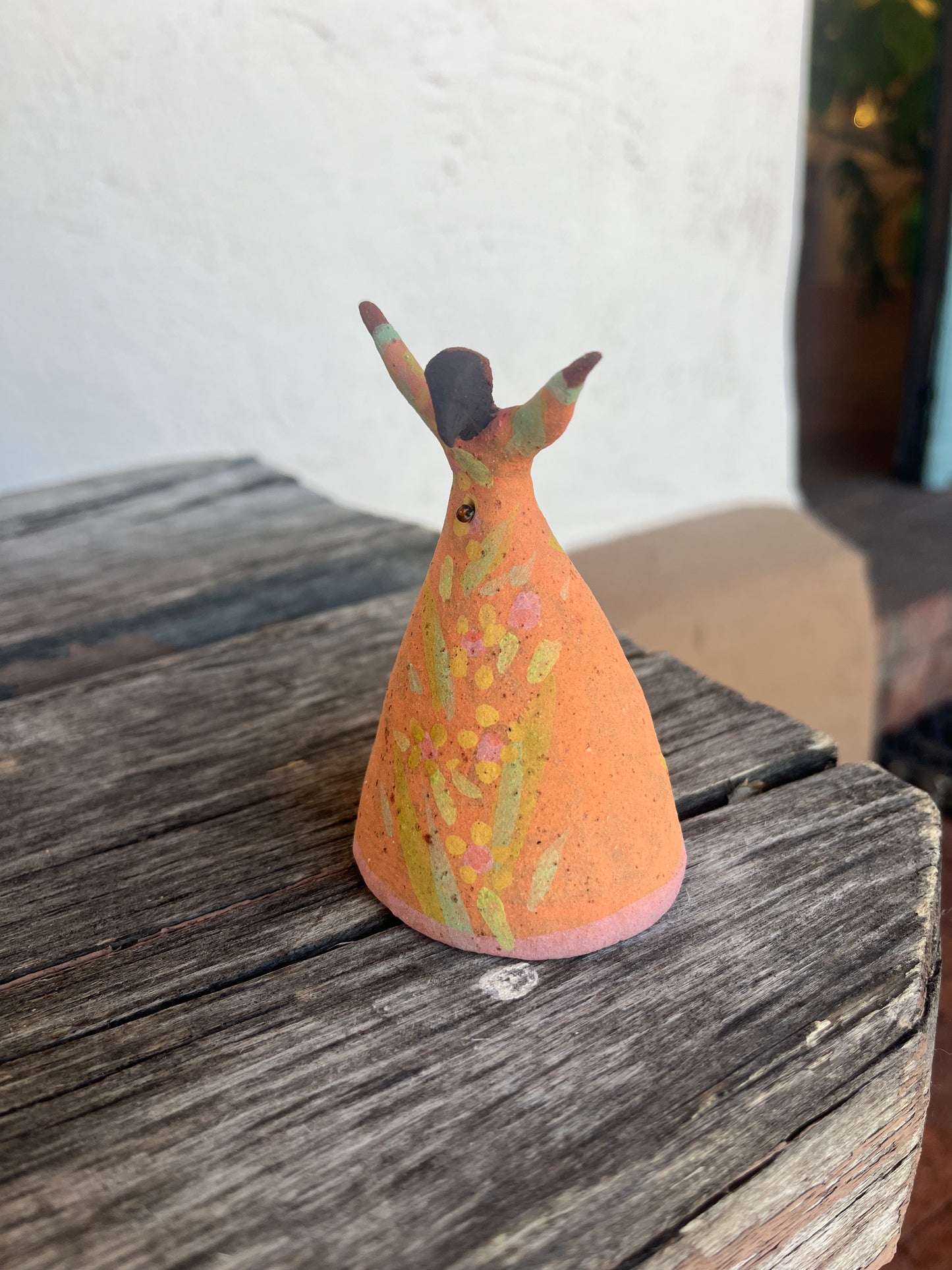 Dancer Bell - Coral dress arms raised