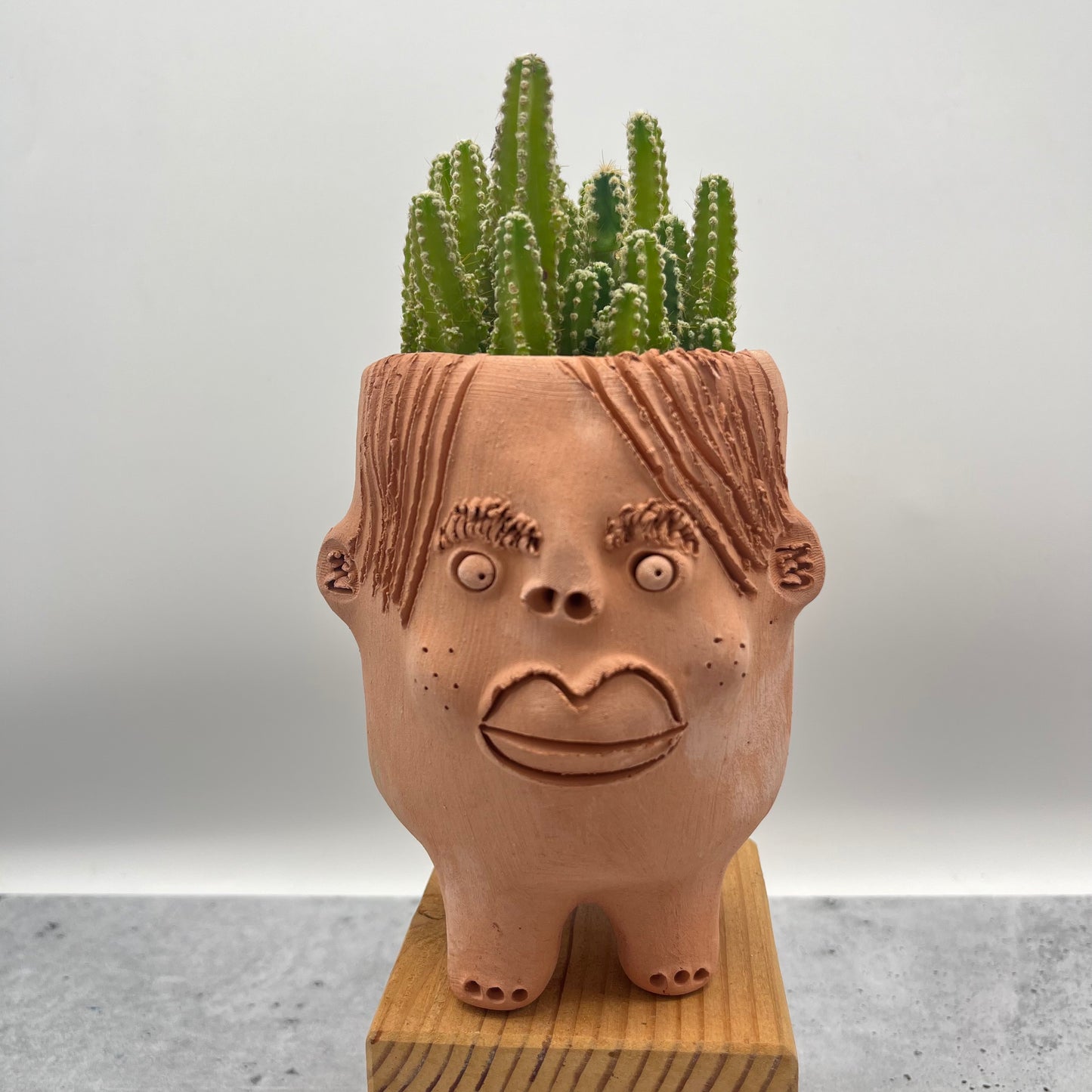 Terracota face planter with legs