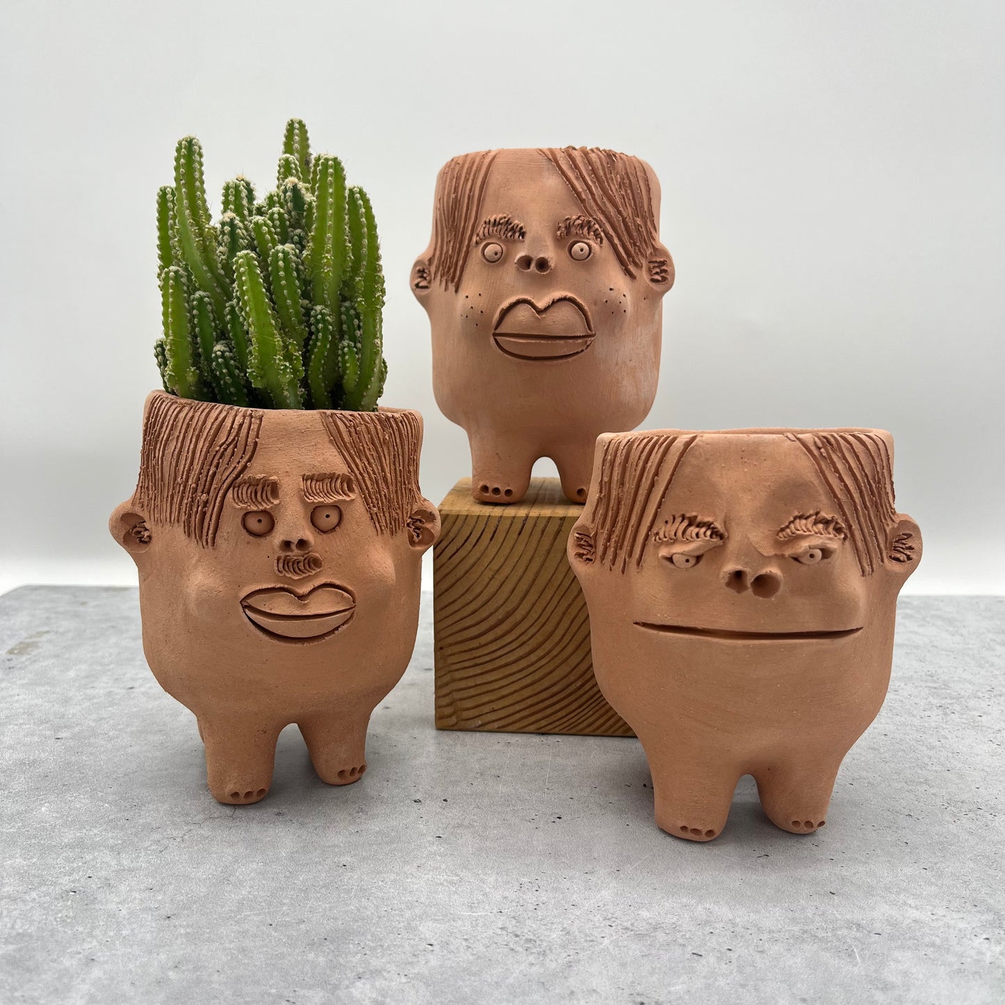 Terracota face planter with legs