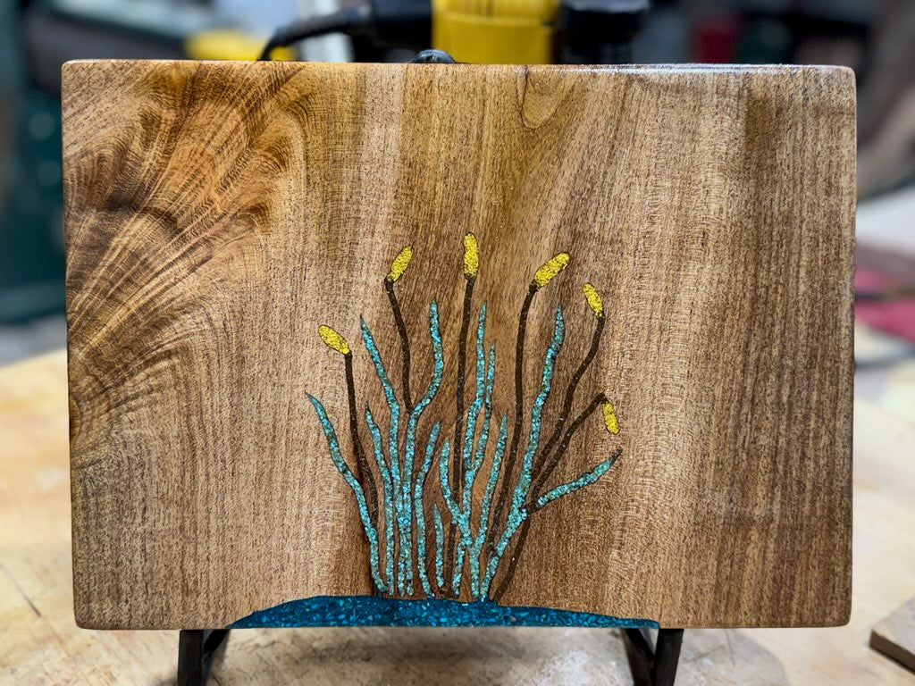 Mesquite charcuterie board with cattil design inlaid in turquoise
