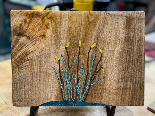 Mesquite charcuterie board with cattil design inlaid in turquoise