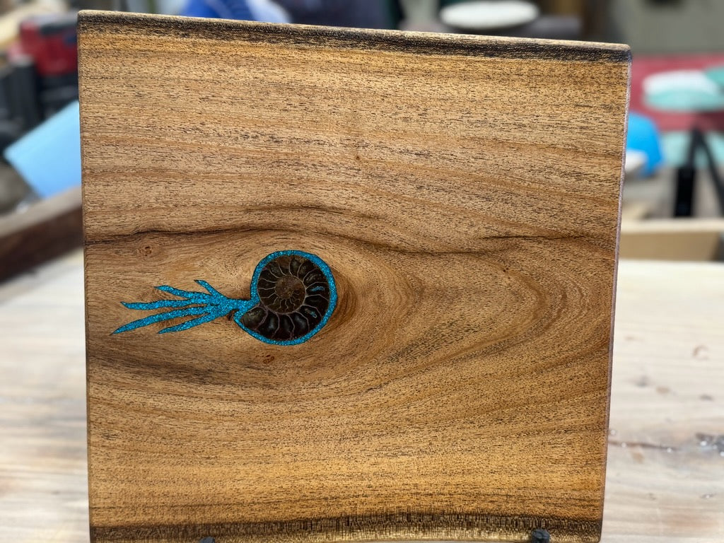 Mesquite charcuterie board inlaid with fossil ammonite and Kingman turquoise