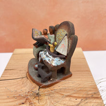 Load image into Gallery viewer, Bench with boat miniature sculpture - yellow rain coat
