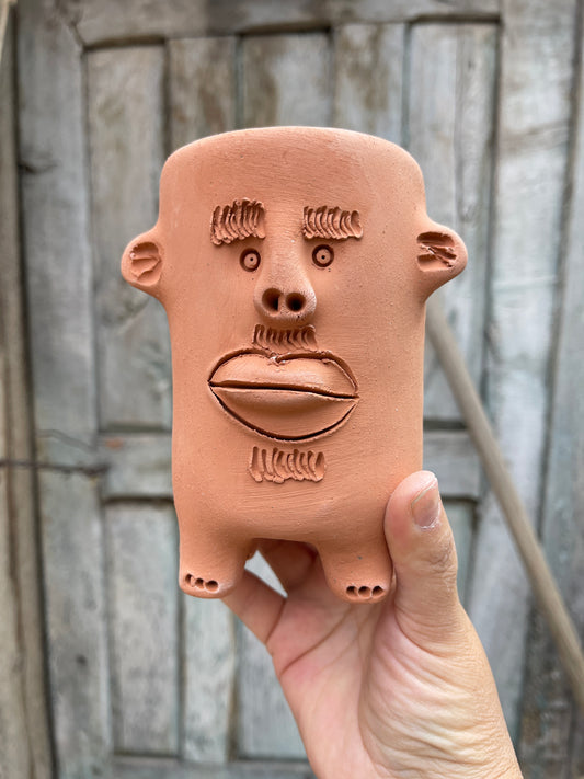 Terracota face planter with legs