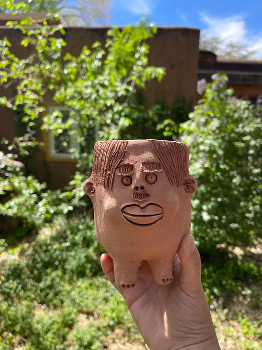 Terracota face planter with legs