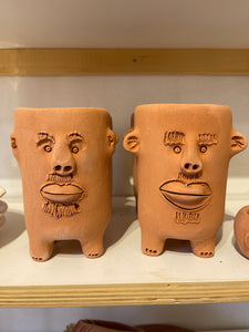 Terracota face planter with legs